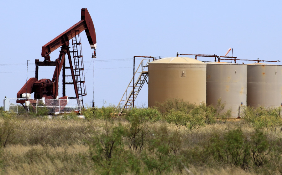 pumpjack and crude oil storage tanks